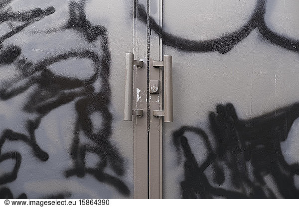 Graffiti and paint covered doorway of abandoned office building