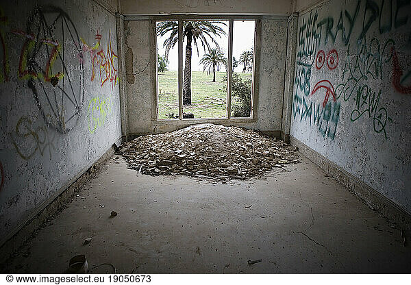 Graffiti covered walls in a abandoned room.