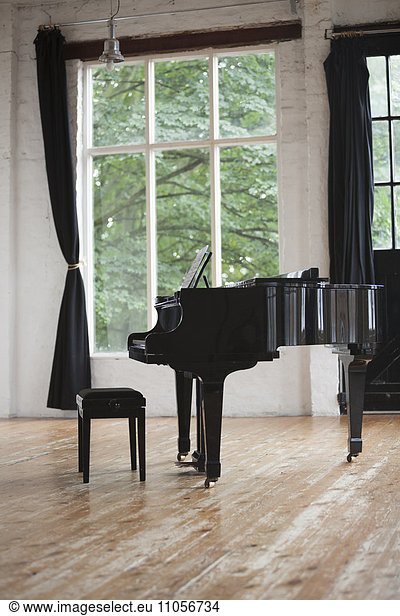 Grand Piano and Piano Stool in a rehearsal studio.