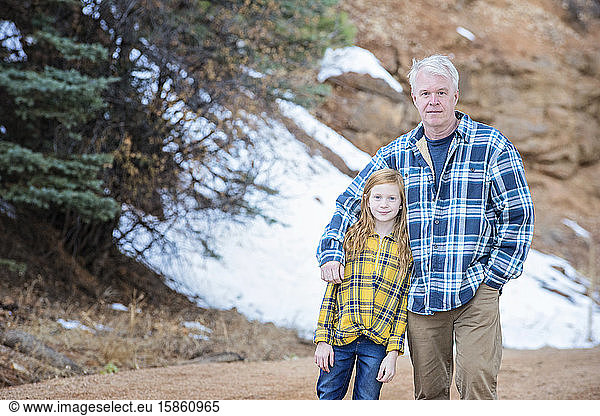 Grandfather and Granddaughter Hiking in the Mountains