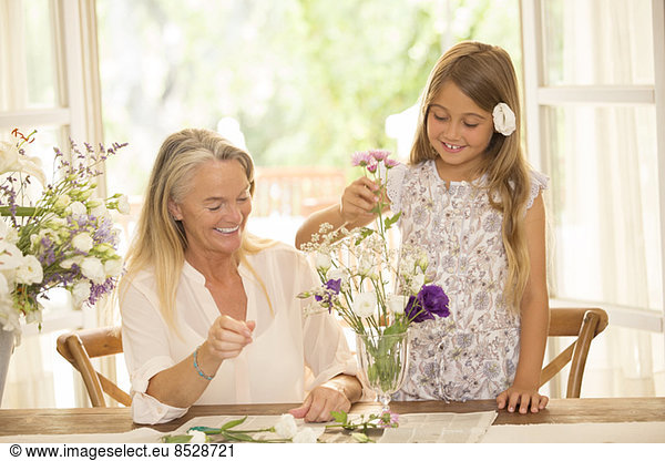 Grandmother and granddaughter arranging flowers