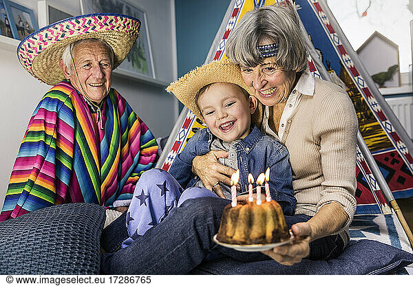 Grandparent celebrating birthday with grandson at home