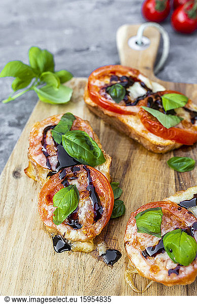 Gratinated baguette slices with tomatoes  mozzarella cheese and basil