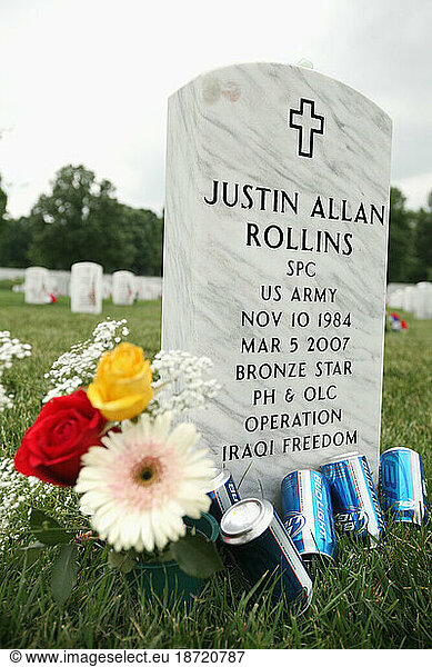Grave sites of soldiers are decorated with memorabilia at Arlington National Cemetery