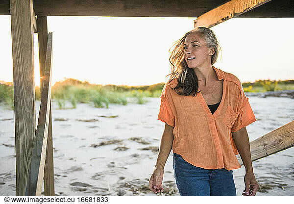 Gray Haired Woman at the beach for sunset