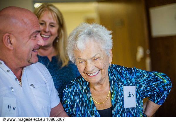 Gray haired woman with friends laughing