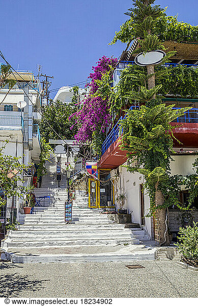 Greece  Crete  Agia Galini  Balcony filled with potted plants overlooking alley steps in summer