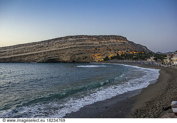 Greece  Crete  Matala  Matala Beach and cliffside caves at dusk