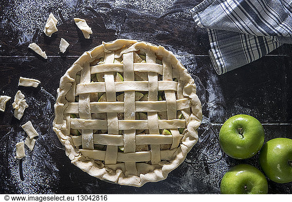 Green apple pie on wooden table