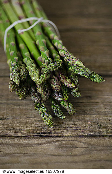 Green asparagus on wooden table  close up