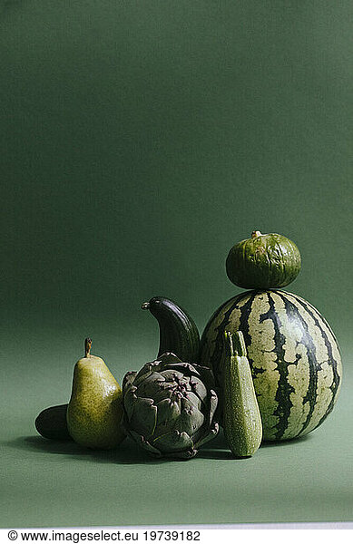 Green fruits and vegetables against green background
