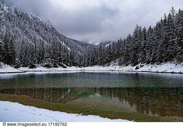 Green lake Gruner see cloudy winter day. Famous tourist destination.