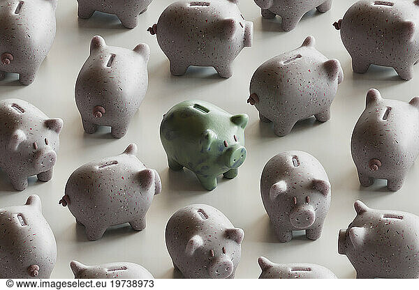 Green piggy bank with many piggy banks over white background