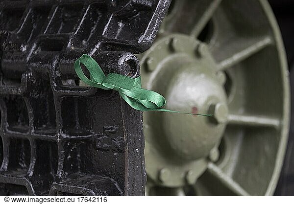 Green ribbon on a tank chain  symbol for peace  Russian citizens use it to protest against the war in Ukraine  Soviet Cemetery of Honour  Burg near Magdeburg  Saxony-Anhalt  Germany  Europe