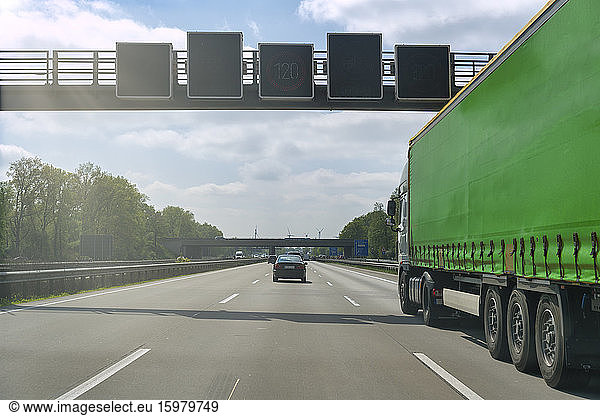 Green truck on motorway