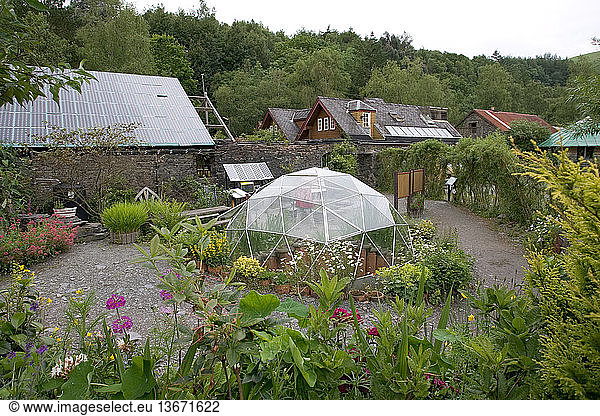 Greenhouse and low-energy houses with photovoltaic panels on the rooftops. Centre for Alternative Technology  Machynlleth  Wales  UK.