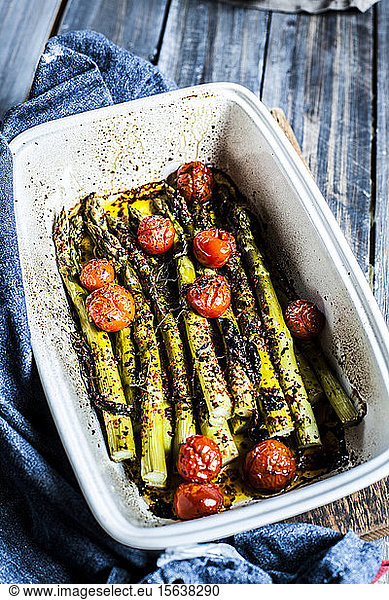 Grilled green asparagus with cherry tomatoes in a casserole