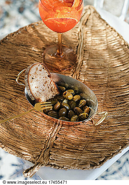 Grilled Mediterranean olives and glass of summer spritz cocktail