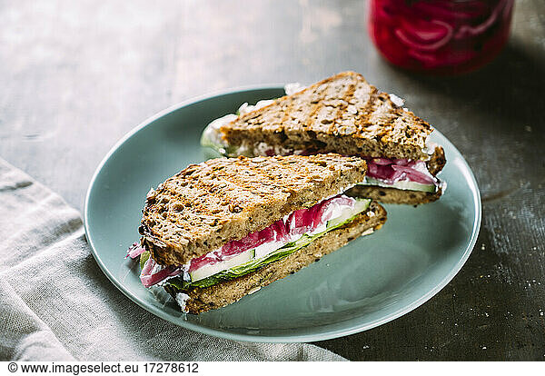 Grilled sandwiches with cucumbers  creamed goat cheese and pickled onions