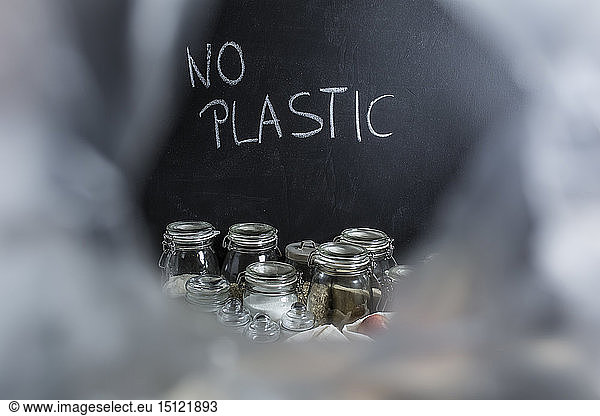 Groceries in jars for waste prevention and writing 'no plastic'