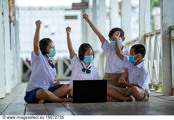 Group of Asian elementary school students wearing hygienic mask