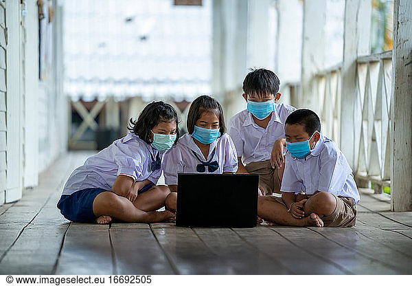Group of Asian elementary school students wearing hygienic mask
