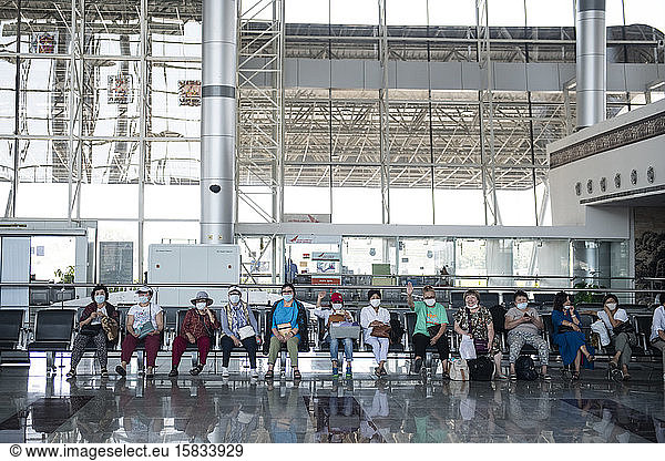 Group of asian passengers waiting at a deserted airport in Khajuraho  Madhya Pradesh  India  due to the health crisis caused by Covid19.