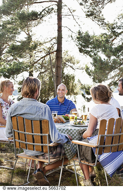 Group of friends dinning together outdoors