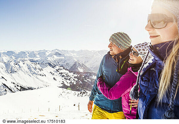 Group of friends enjoying the view from a mountain peak in winter  Achenkirch  Austria