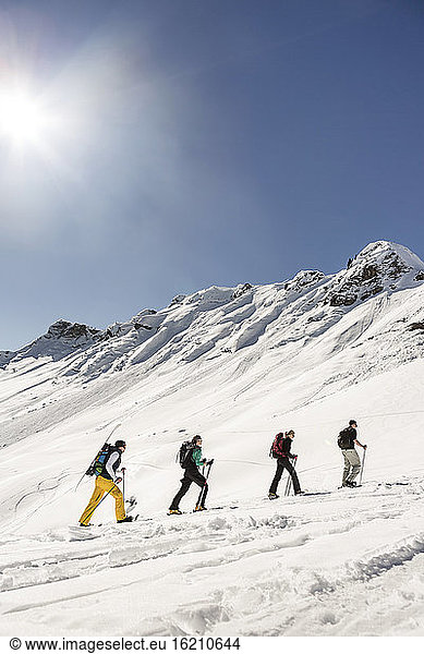 Group of friends ski touring up to a mountain peak  Achenkirch  Austria