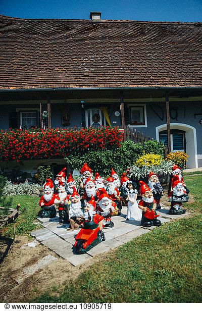 Group of garden gnomes in front of Austrian farmhouse