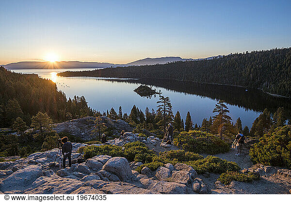 Group of photographers taking pictures of sunrise at Emerald Bay in Lake Tahoe  California  USA