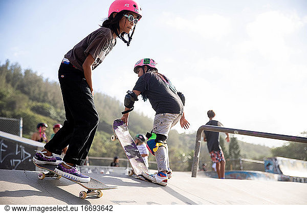 Group of skaters in outdoor skate park in hawaii