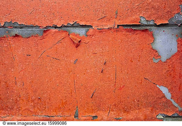 Grunge Concrete Wall Texture peeling paint  old cracked wall peach or pink colored closeup.