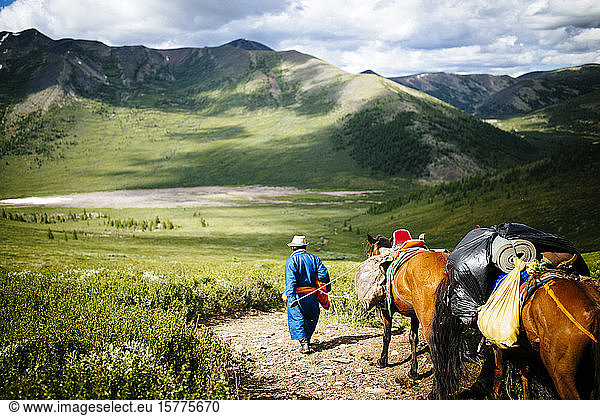 Guides and travelers ride horses into the East Taiga forests of northern Mongolia to visit the remote  nomadic reindeer herders that live near the Siberian borders of the country.
