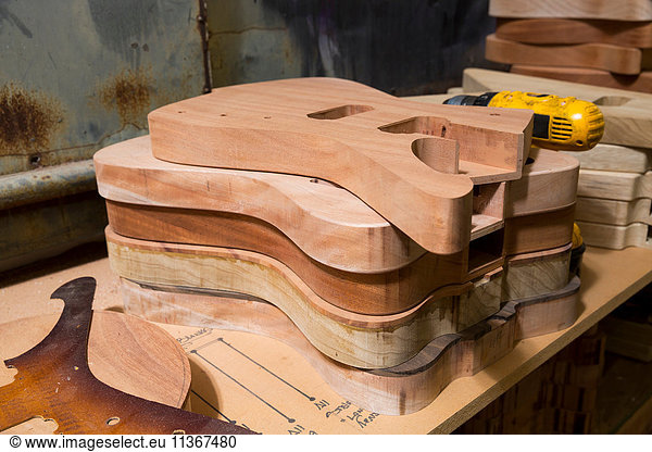 Guitar bodies stacked in workshop