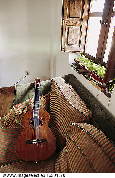 Guitar on sofa in living room