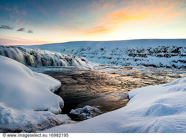 Gulfoss Iceland waterfall at sunrise in snowy winter