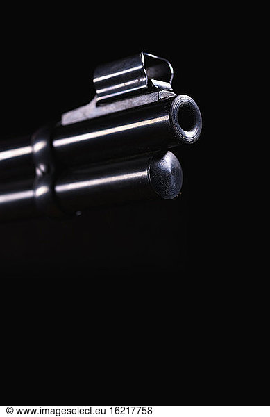 Gun barrel against black background  close up