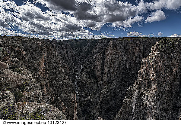 Gunnison river passing through canyons against cloudy sky
