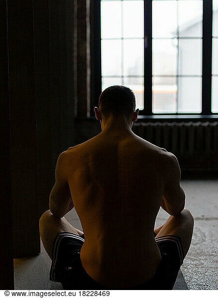Guy meditates in the gym