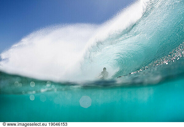 guy surfing a powerful wave in midwater shoot