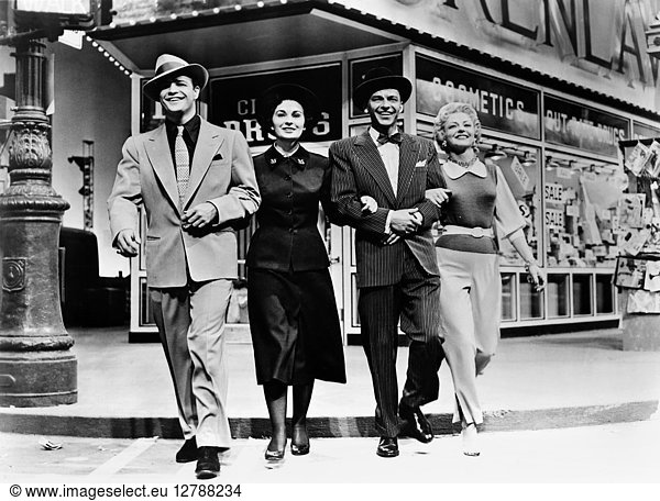 GUYS AND DOLLS  1955. Left to right: Marlon Brando  Jean Simmons  Frank Sinatra  and Vivian Blaine in a scene from the film version of the musical 'Guys and Dolls ' directed by Joseph L. Mankiewicz  1955.
