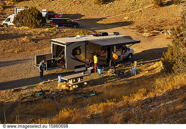 Guys setting up camp in a motorhome.
