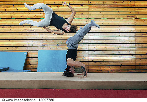 Gymnasts practicing gymnastics at gym