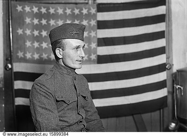 Half-Length Portrait of American Soldier with American Flag in Background  France  Lewis Wickes Hine  American National Red Cross Photograph Collection  October 1918