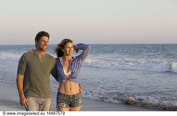 Half-Length Portrait of Smiling Mid-Adult Couple at Beach