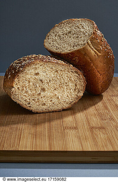 Half loaf of bread on cutting board indoors
