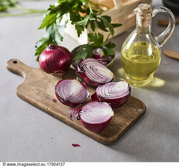 Halved onions and jug of olive oil