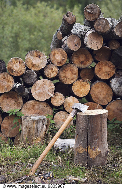 Hammer and stacked firewood at yard
